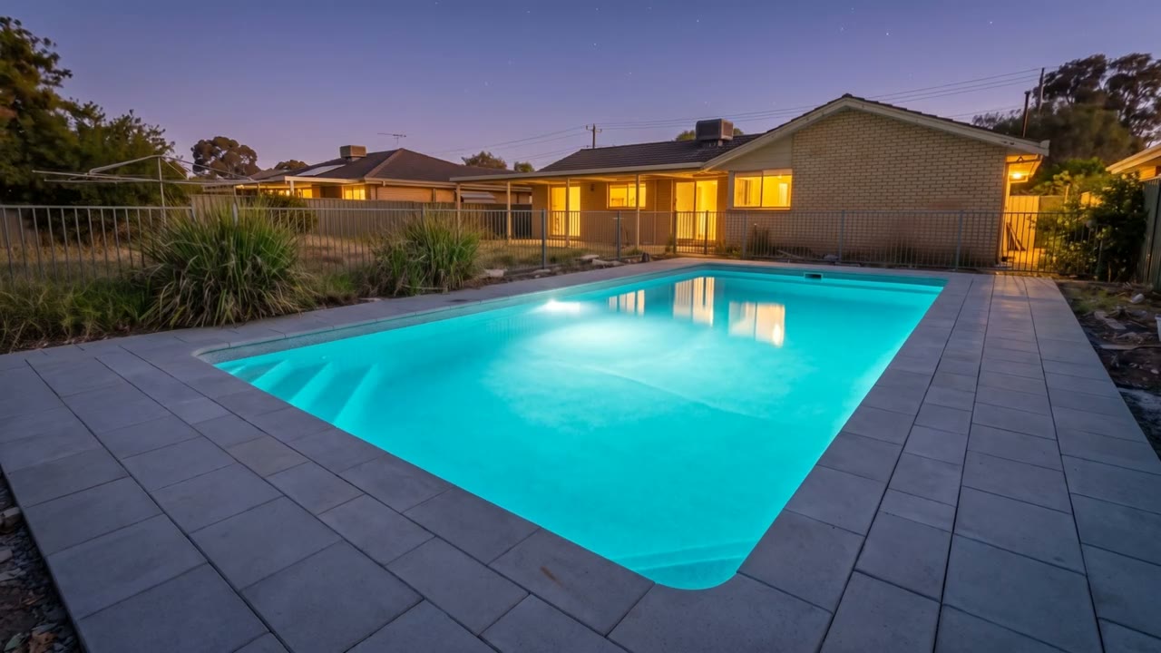 Finished pool at night, lit and full